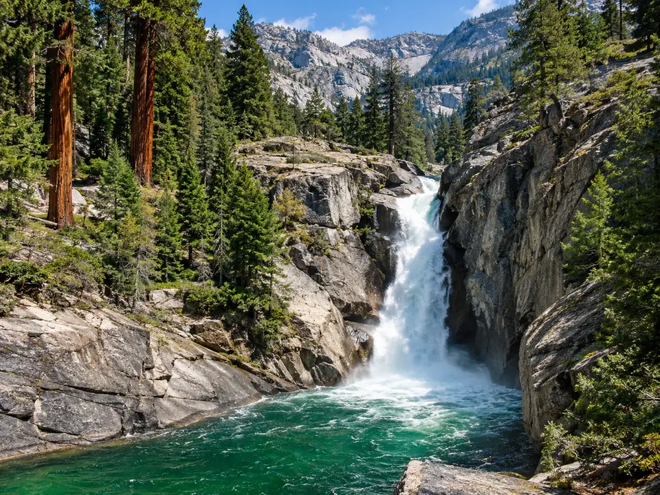 A waterfall pouring through a granite chute into a pool