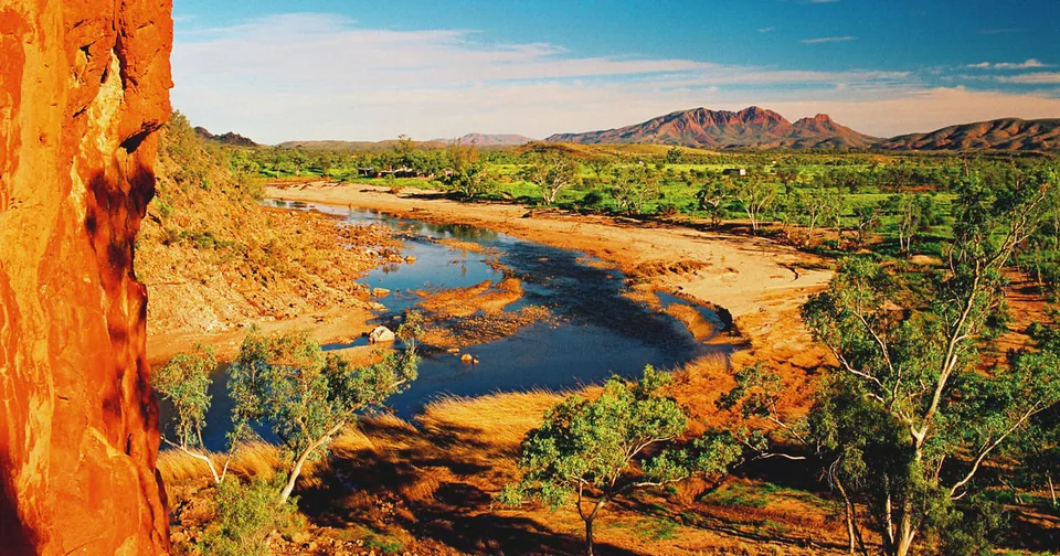A river pool between red cliffs in the West MacDonnell Ranges