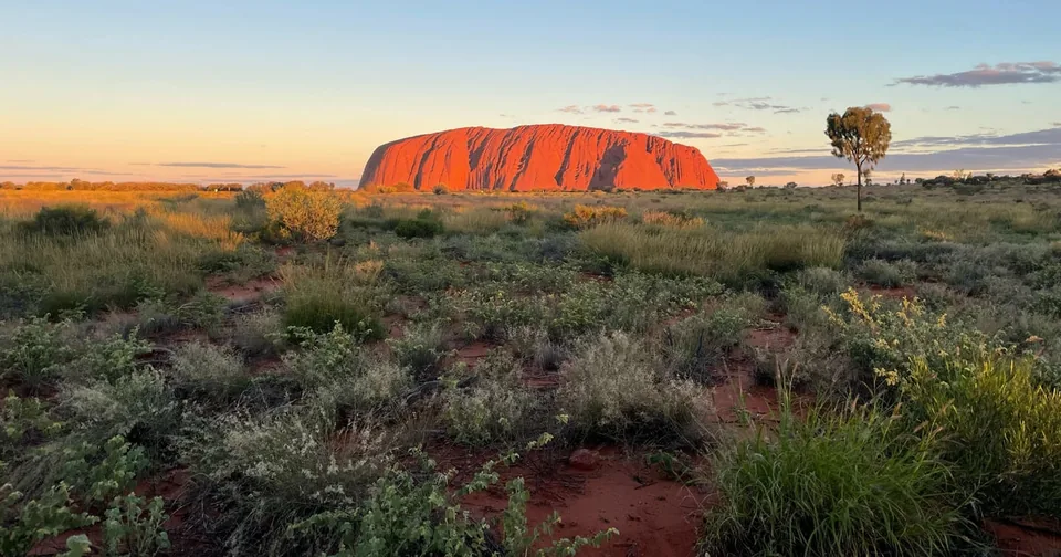 Uluru glowing red at sunset